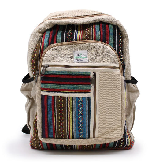 A tan backpack with colorful striped accents stands against a white background. A front pouch displays the label, "Himalayan made with pure hemp."