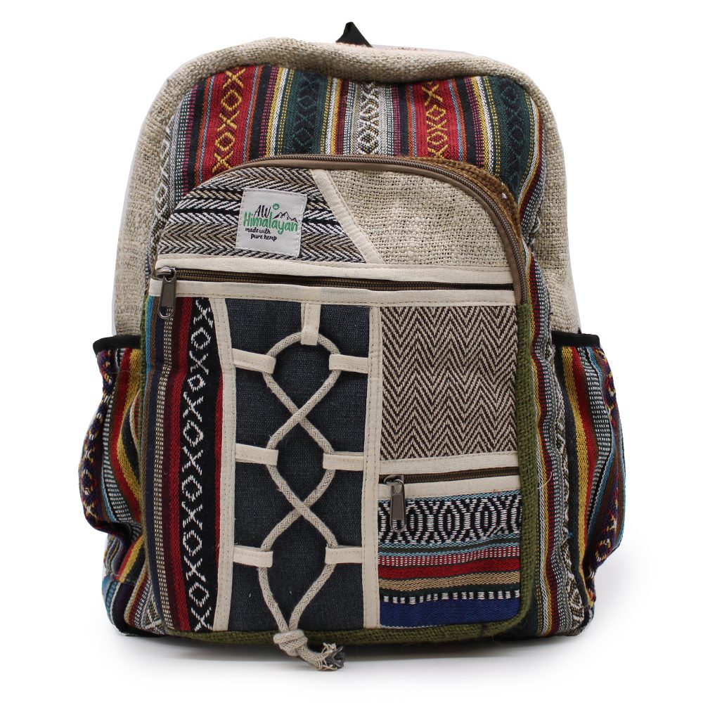 A colorful hemp backpack stands upright, featuring multiple zippered compartments and an "AW Himalayan made with pure hemp" tag. Its exterior showcases various patterns, stripes, and textures.