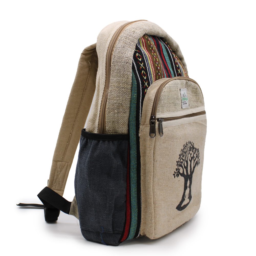 A hemp backpack stands on a white surface, featuring a beige main body, striped accent fabrics, a front pocket with a tree design, and "hemp" visible on a small label.