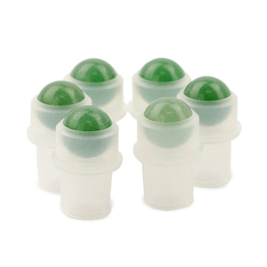 Six green rollerballs stand upright in frosted plastic containers on a white surface, arranged in a circular, slightly staggered formation.