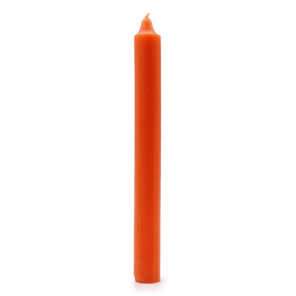 An orange candle stands upright on a bright white surface. The candle is smooth and cylindrical with a pointed tip.