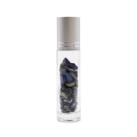 A clear, cylindrical bottle with a silver cap is filled with blue and gray stones. It rests on a white surface.
