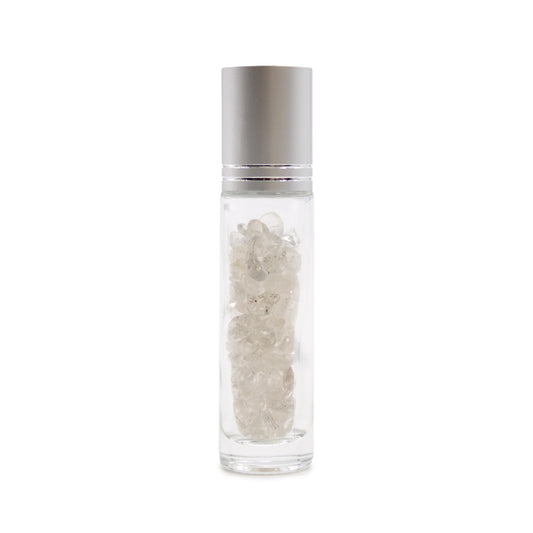 A clear glass roller bottle with a silver lid sits upright, filled with what appear to be small clear crystals. It is isolated on a bright white background.