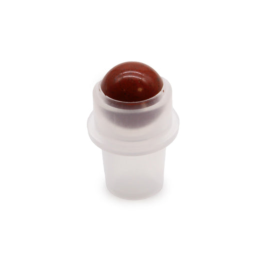 A translucent applicator holds a mottled red, round stone, likely for applying oils. It stands on a plain, white background.