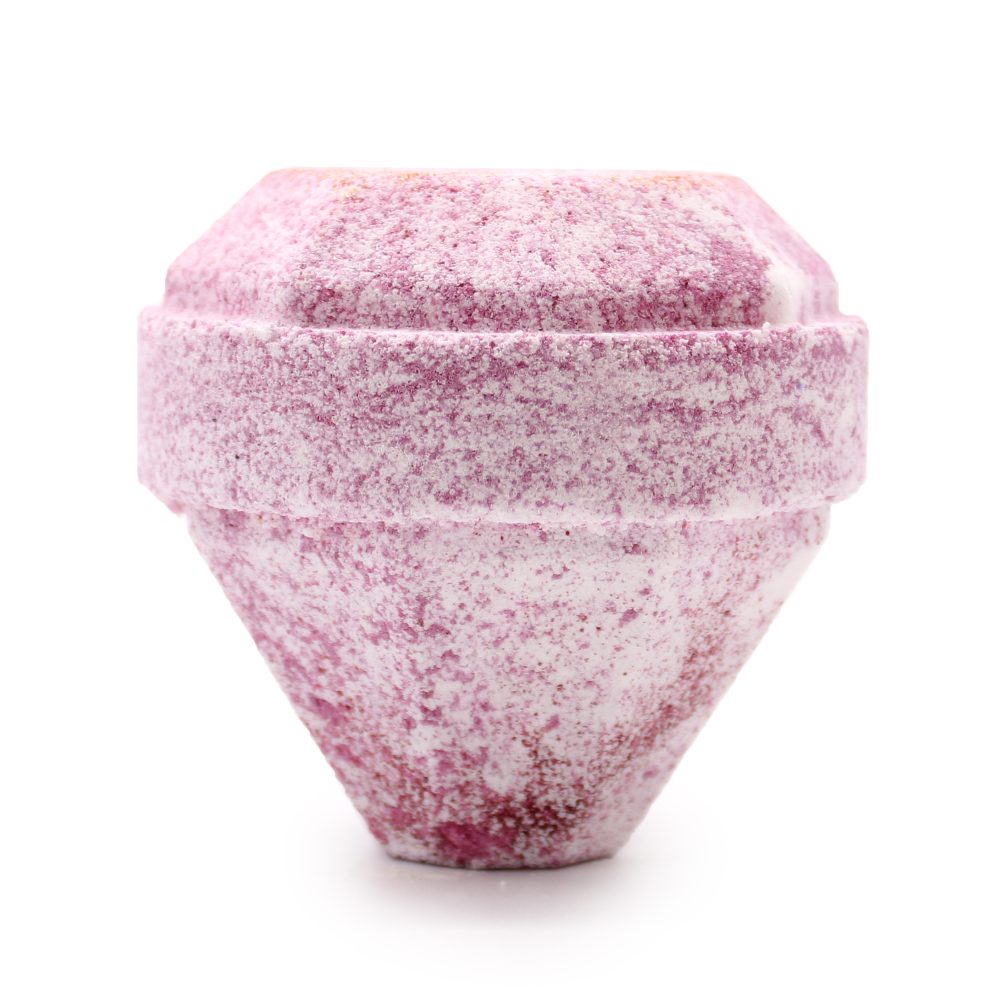 A pink and white speckled, conical bath bomb sits upright against a plain white background, showcasing its compact, textured form.