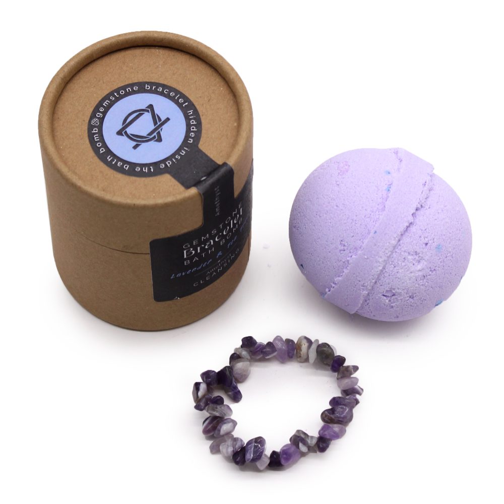 A purple bath bomb, a gemstone bracelet, and a round cardboard box, labeled "Gemstone Bracelet Hidden Inside the Bath Bomb," on a white background. Text on the box: "Lavender Apothecary Cleanse."