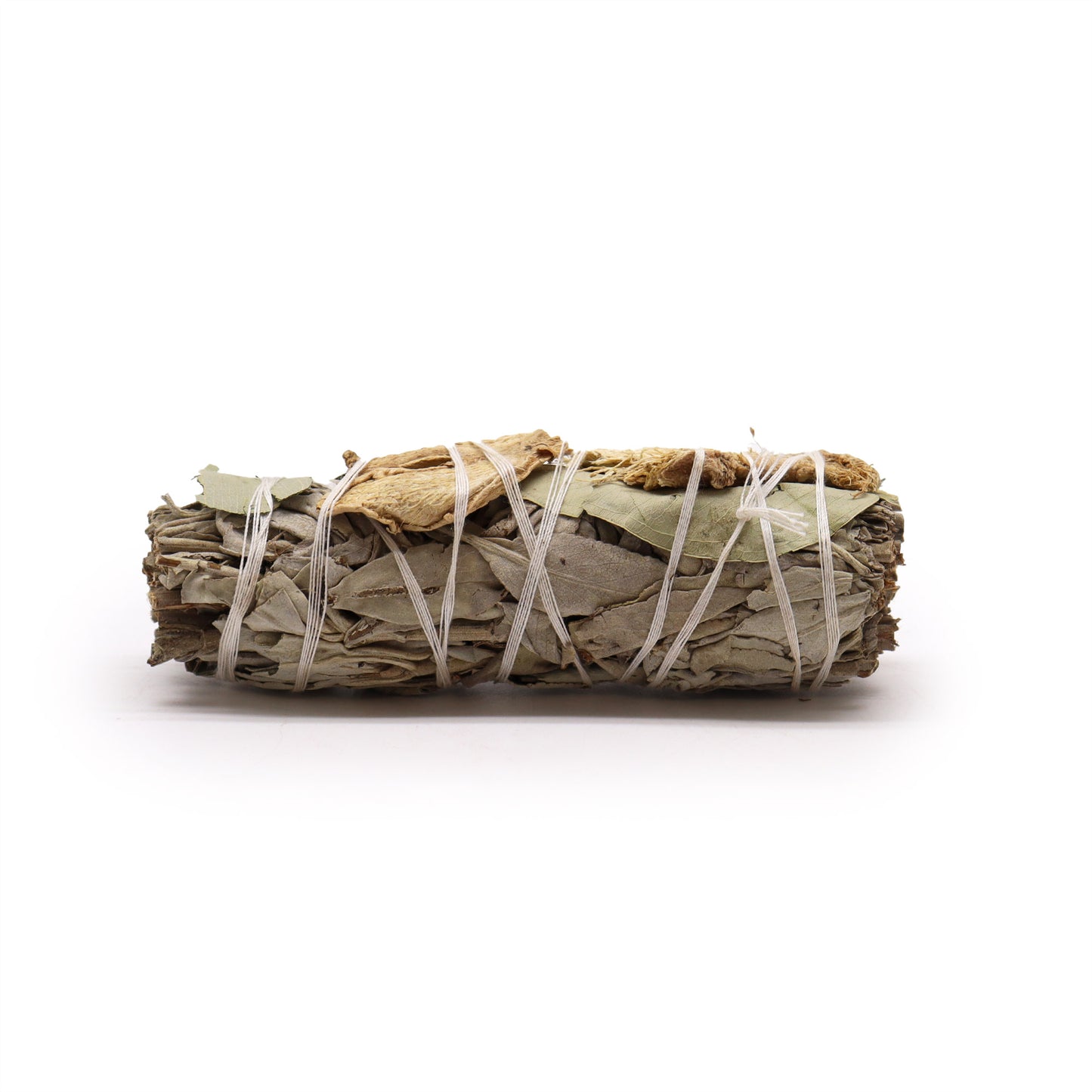 A smudge stick, bound with twine, rests on a white background.
