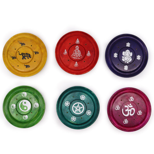 Six round incense holders display spiritual symbols. Yellow with elephants, red with Buddha, purple with Ganesh, green with yin-yang, teal with pentagram, and maroon with Om.