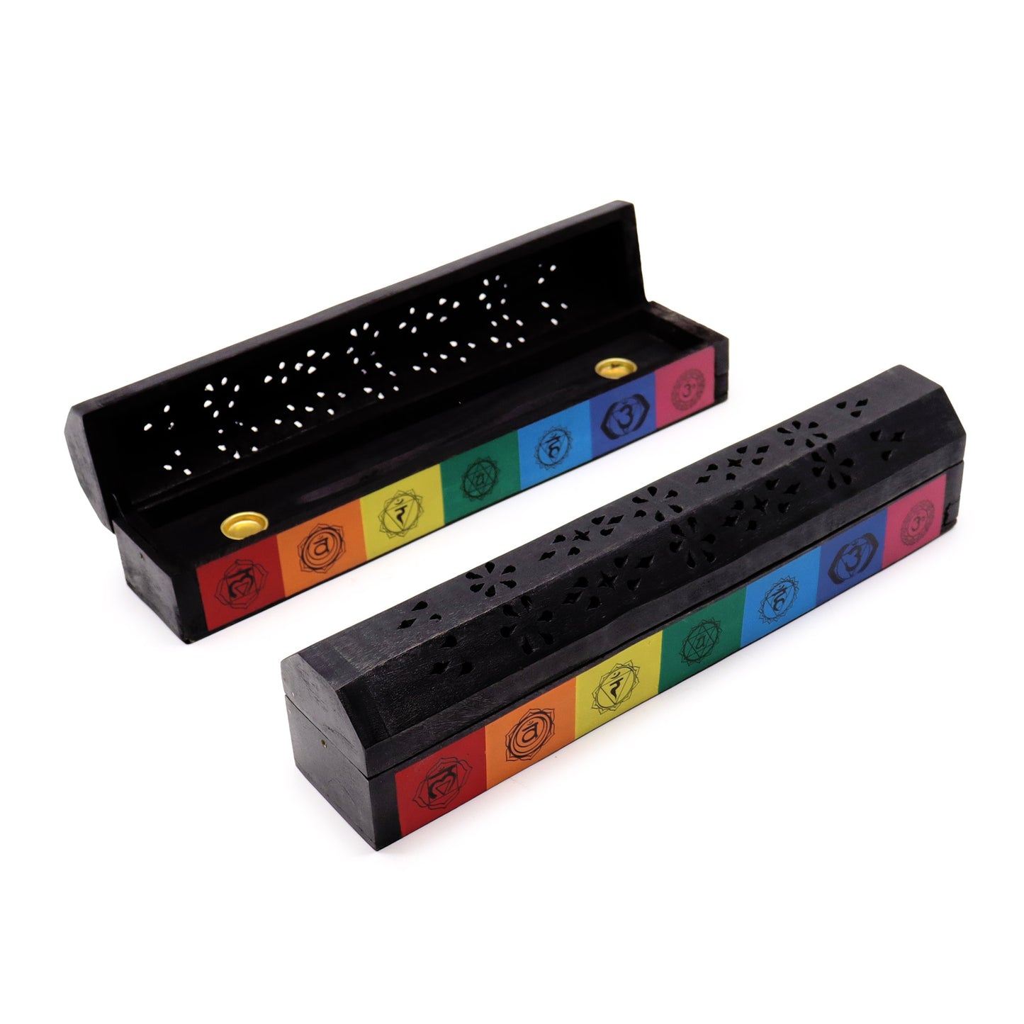 Black incense boxes with finely cut floral patterns, each featuring a rainbow of chakra symbols, rest on a white surface. One box is open, showing the interior and incense holder.
