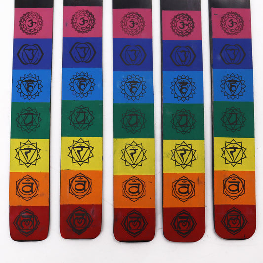 Five rainbow gradient incense holders display chakra symbols. Each holder features bands of color from red to purple, with chakra symbols corresponding to each color band, set against a white background.