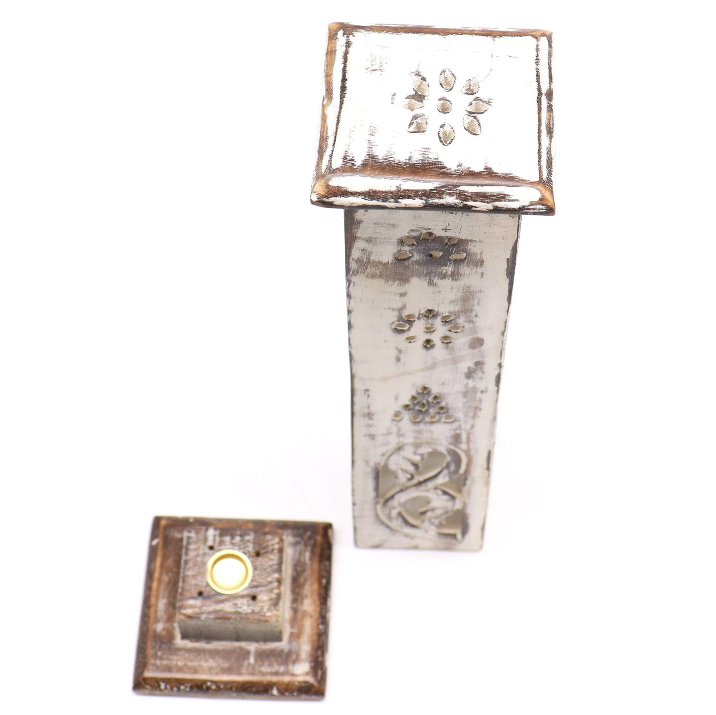A tall, decorative, rustic wooden box with a removable lid featuring floral carvings, stands upright on a white surface. The lid is placed beside the box.