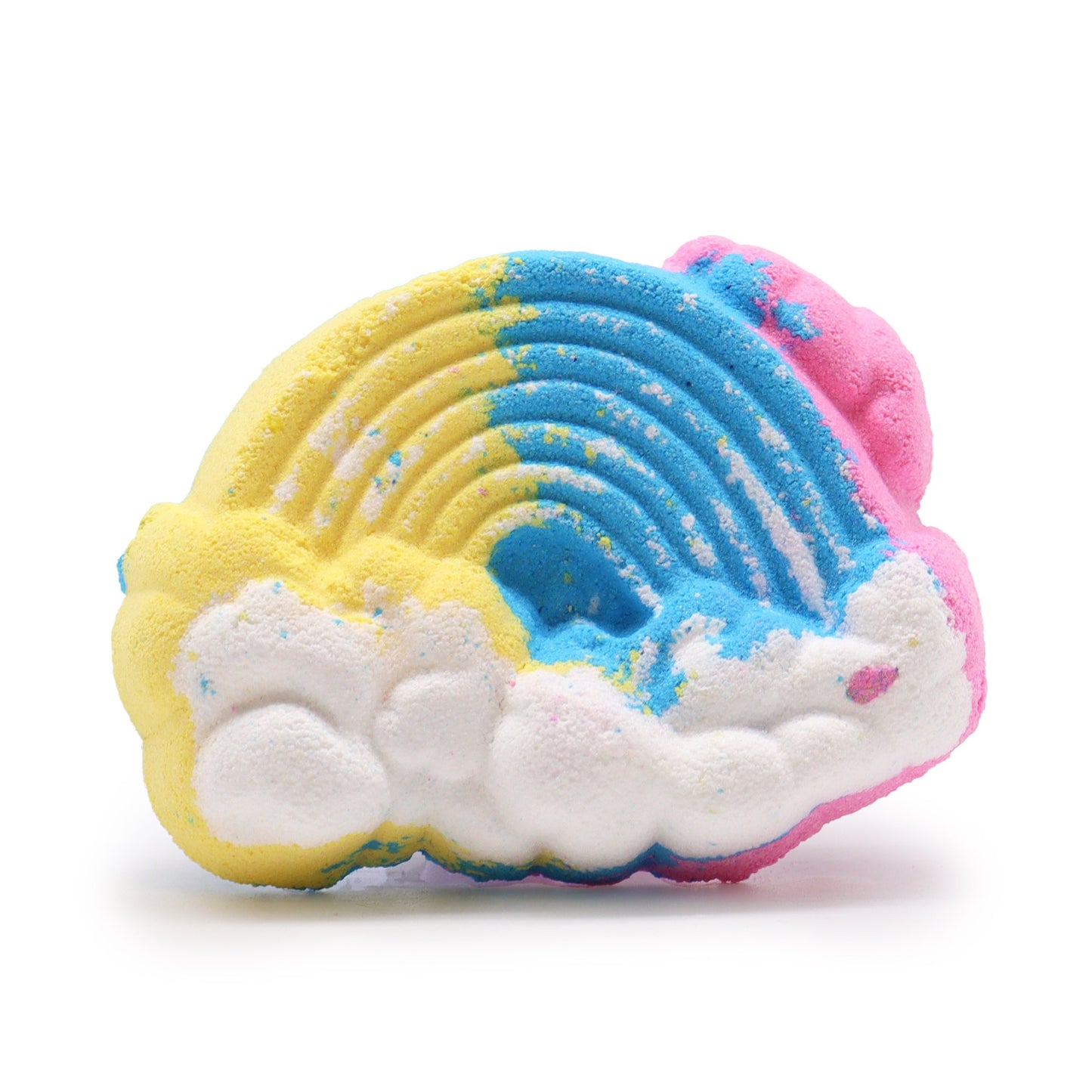 A rainbow-shaped bath bomb features vibrant blue, yellow, and pink hues with cloud patterns beneath, set on a plain white background.