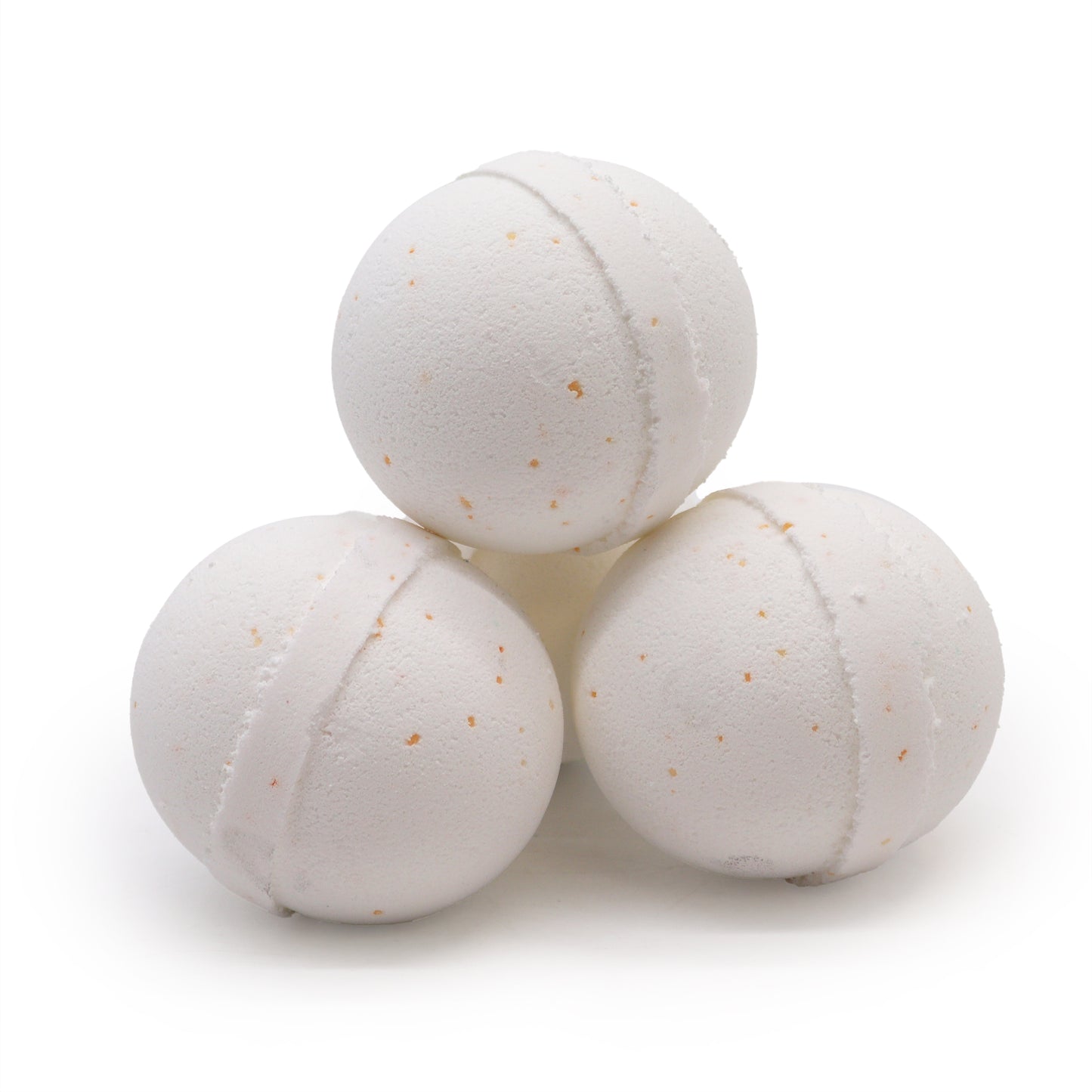 Three white bath bombs with subtle specks, stacked together, rest against a plain white background.