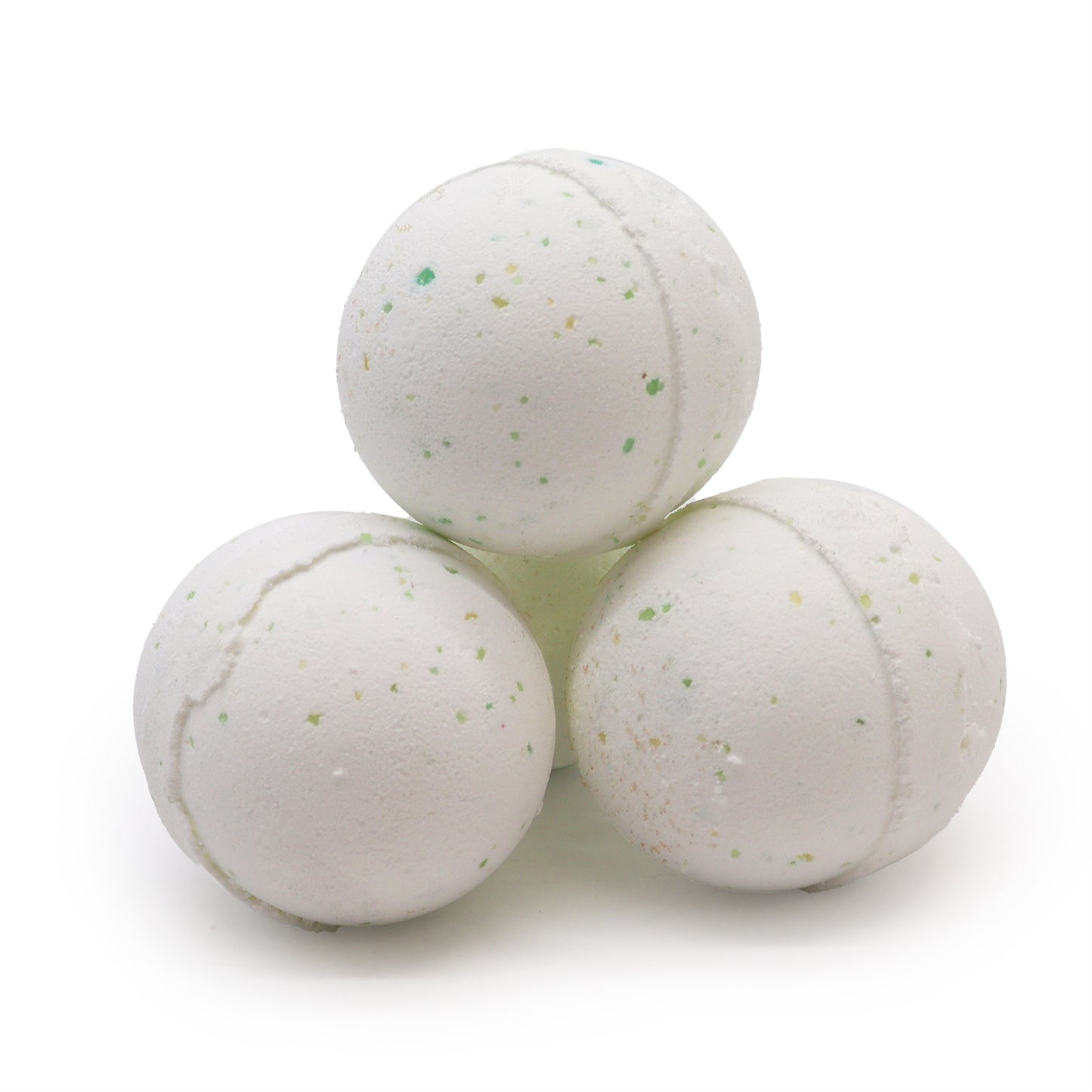 Three white bath bombs speckled with green and yellow, stacked in a pyramid shape, against a plain white background.
