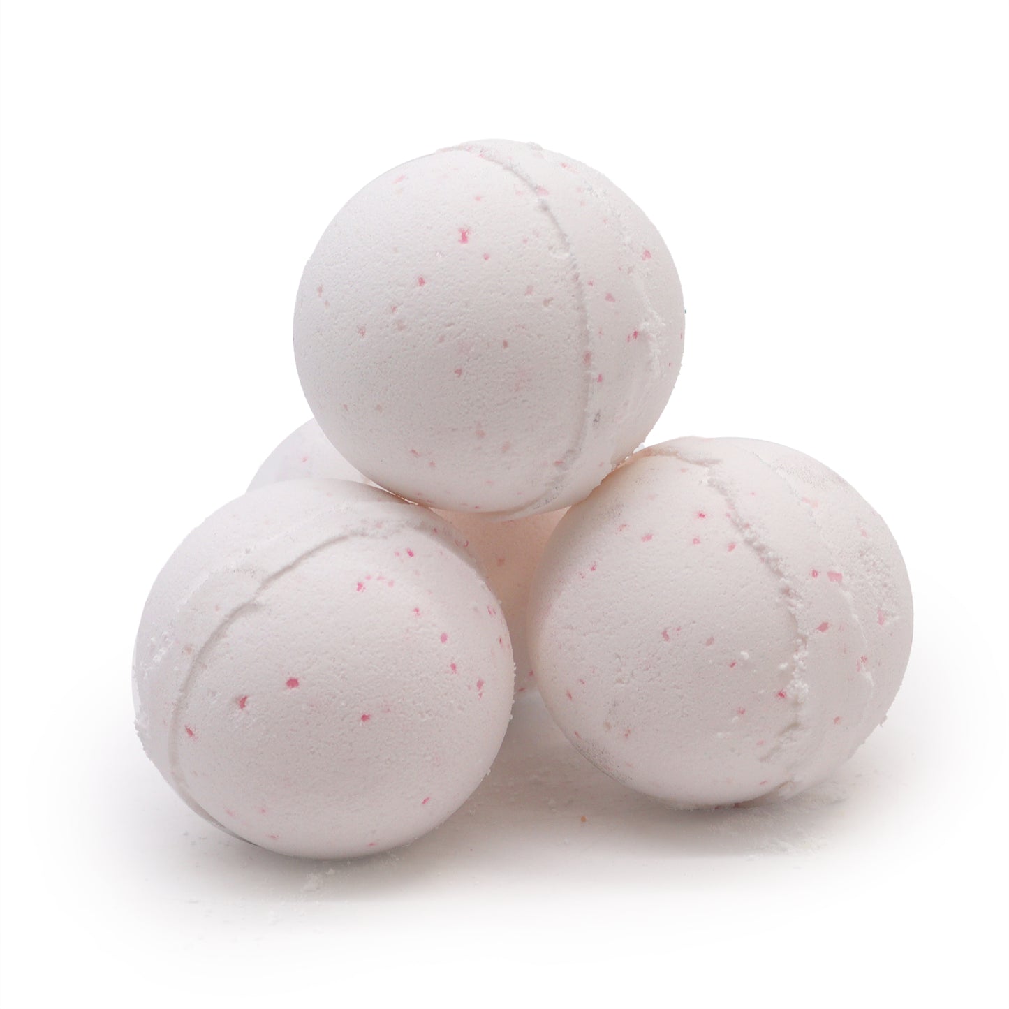 Four white bath bombs, each with faint pink speckles, are stacked in a pyramid formation on a plain white background.