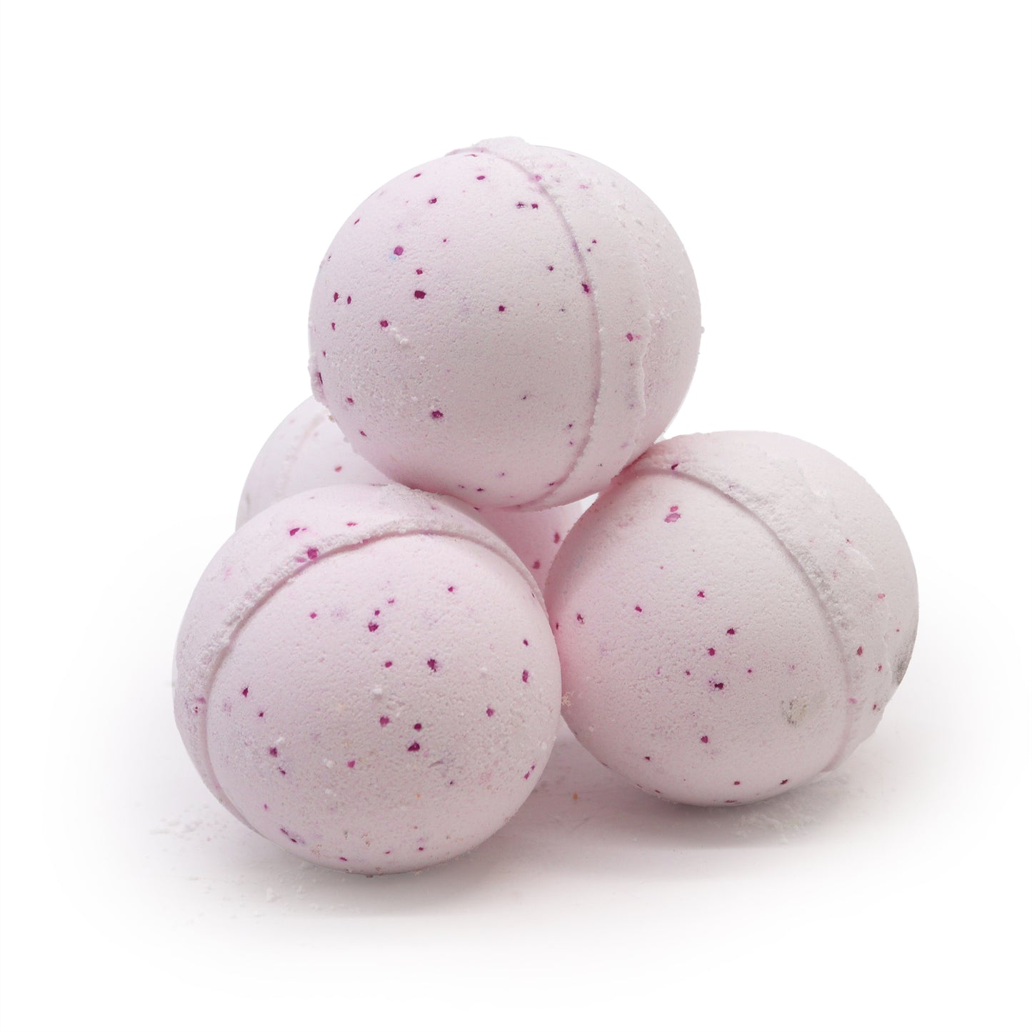 Pink spherical bath bombs are stacked in a pyramid formation. They have small purple speckles and are placed on a plain white background.