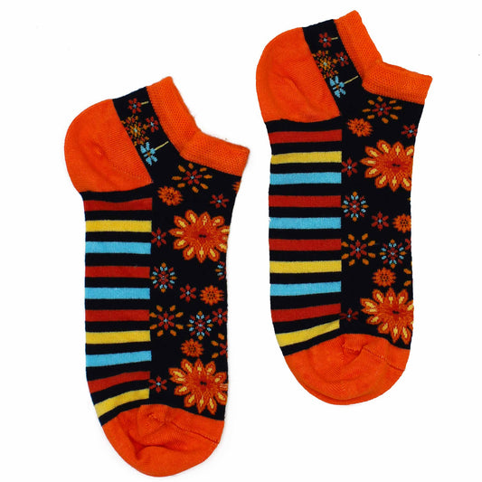 A pair of ankle socks, patterned with orange flowers and stripes, lies on a white background.
