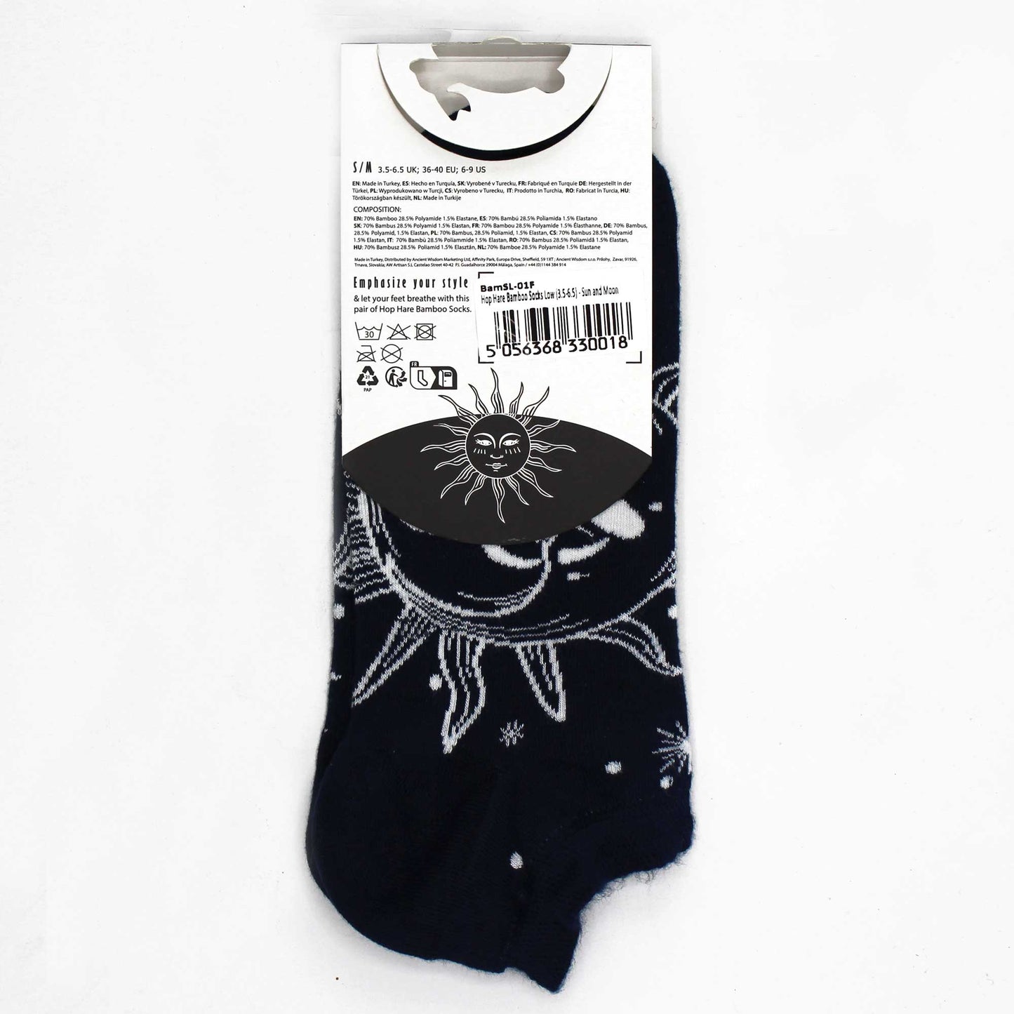 Dark blue socks, displaying a sun and moon pattern, are presented on a white background with their packaging tag. The tag details sizing, composition (70% bamboo, 28.5% polyamide, 1.5% elastane), and care instructions. The product name is "Hop Hare Bamboo Socks Low (3.5-6.5) - Sun and Moon" and the code is BamSL-01F.