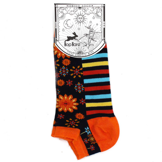 A pair of colorful ankle socks, featuring a floral and striped pattern, is displayed against a white background. The socks have an orange cuff and are attached to a tag that reads: "*BAMBOO SOCKS* Hop Hare YOUR BAMBOO WEAR".