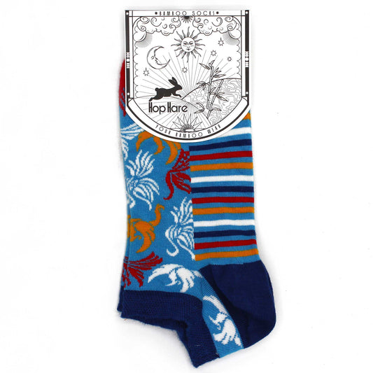 A pair of bamboo socks, featuring a whimsical design, is displayed against a white background. The socks are predominantly light blue with a striped and patterned section. The attached tag reads: *BAMBOO SOCKS* Hop Hare YOUR BAMBOO WEAR.