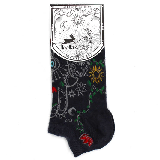 A dark-navy sock, decorated with colorful designs, is displayed against a white background. Attached is a tag reading "*BAMBOO SOCKS*", "Hop Hare", and "YOUR BAMBOO WEAR".