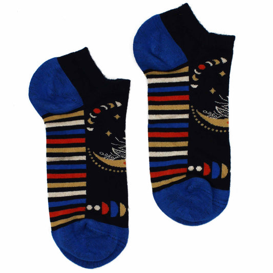 A pair of ankle socks lies on a white background. They are dark blue with multicolored stripes and celestial designs.