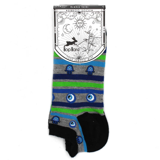 A pair of striped bamboo socks, featuring hamsa and evil eye patterns, is displayed against a white background with its attached label.
