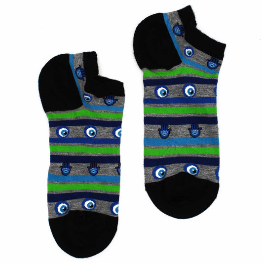 Two ankle socks, patterned with blue eyes and Hamsa hands on grey and green stripes, lie on a white background.