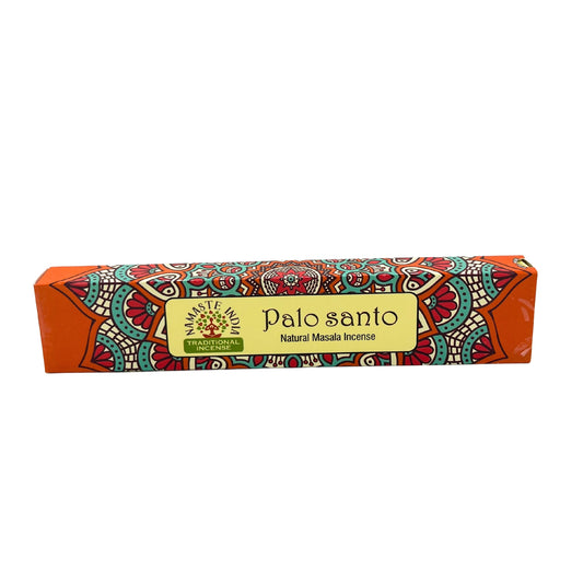 Box of incense rests horizontally, displaying vibrant, intricate mandala patterns. Text reads: "Palo Santo Natural Masala Incense" and "Namaste India Traditional Incense." The background is primarily orange.