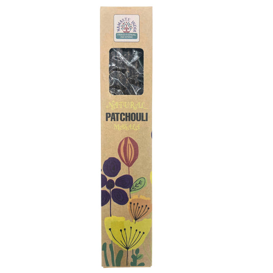 A cardboard incense box displays "NAMASTE INDIA TRADITIONAL INCENSE" with "NATURAL PATCHOULI MASALA" written below. It features floral illustrations and a clear window showing contents inside.