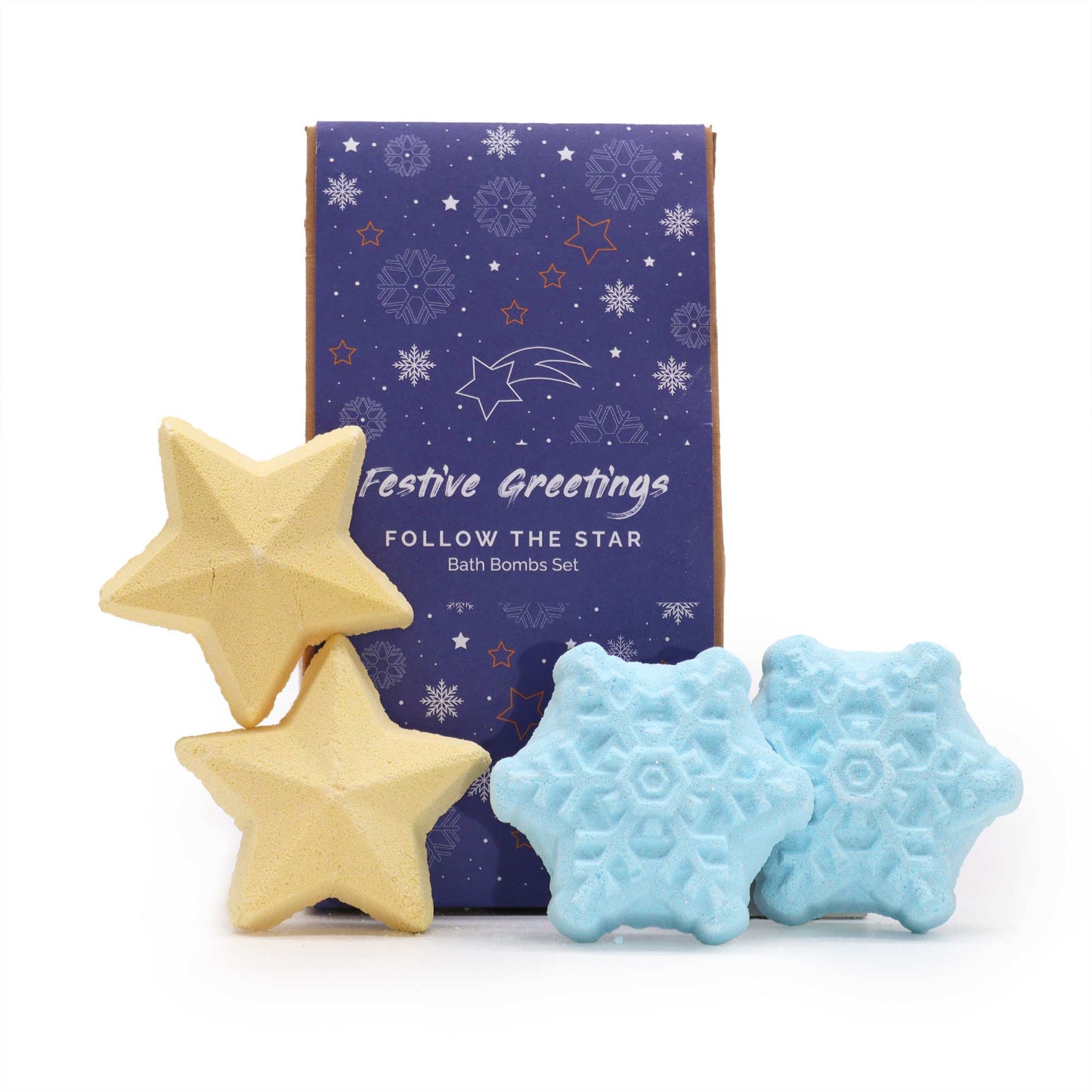 Two star-shaped yellow bath bombs and two snowflake-shaped blue bath bombs are in front of a purple box labeled "Festive Greetings, FOLLOW THE STAR, Bath Bombs Set," with snowflake and star patterns.