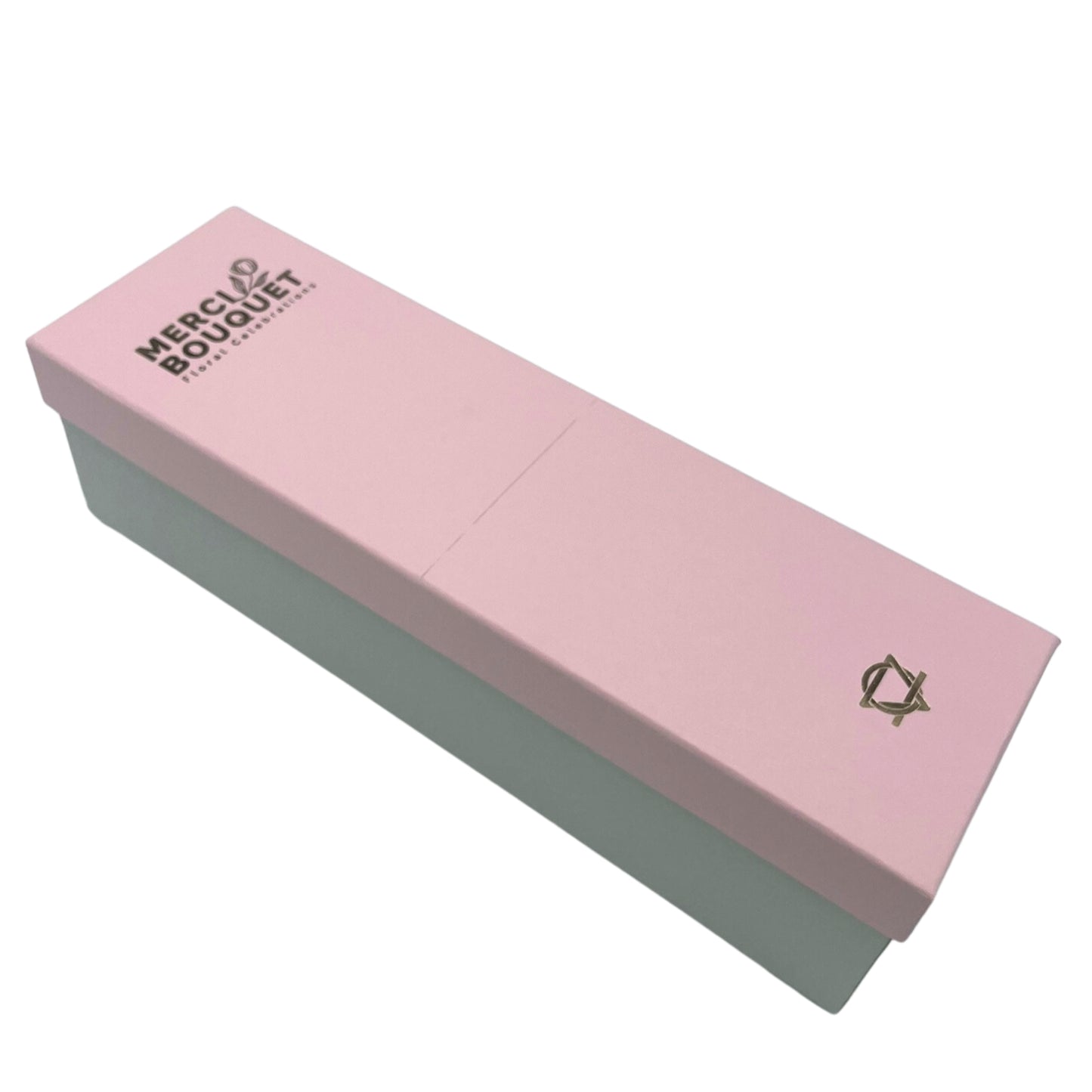A pink box with a light-green base sits on a white background. The box is labeled "MERCI BOUQUET Floral Celebrations". A logo is present on the bottom right corner.