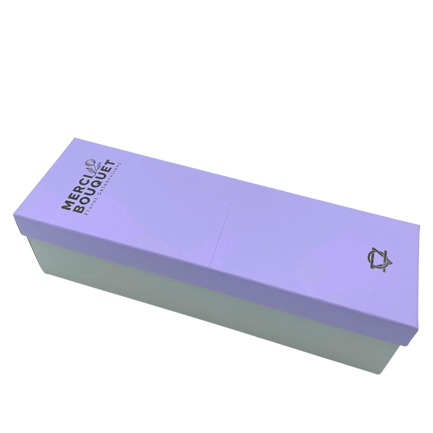 A lavender-colored rectangular box sits on a white background. The box is printed with "MERCI BOUQUET Floral Celebrations" and a small logo.