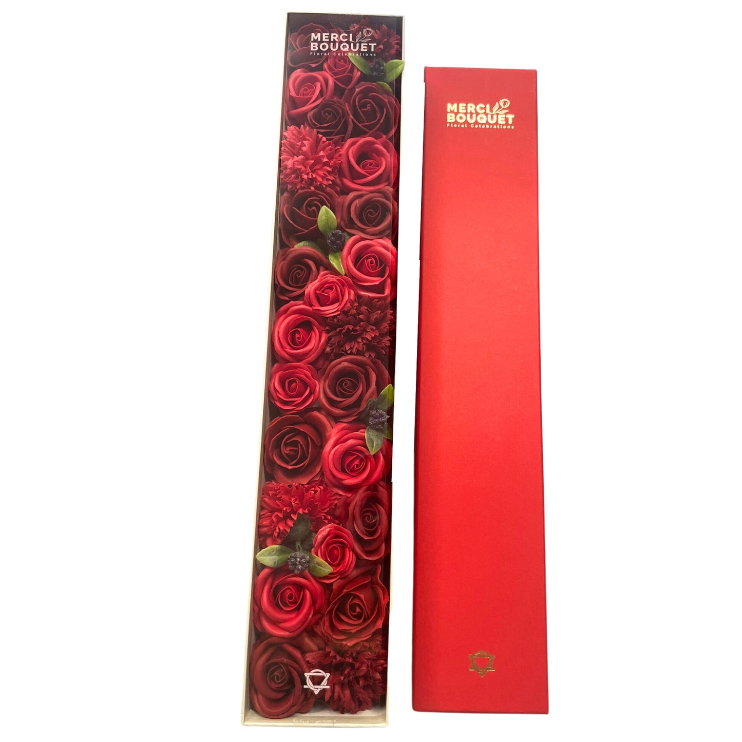 A long box containing a bouquet of red and burgundy roses and carnations sits next to a matching red box. The boxes are labeled "MERCI BOUQUET Floral Celebrations".