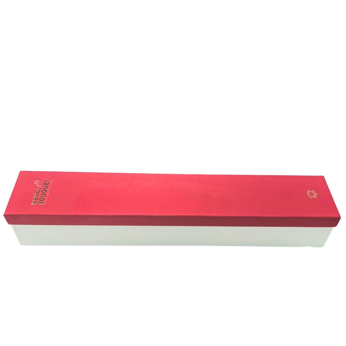 A long, rectangular box sits on a white background. The box is red on top and white on the bottom. The top displays "MERCI" and "BOUQUET" in gold lettering.