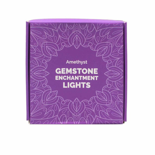 A purple box is displayed against a white background, adorned with symmetrical, repeating floral patterns. The text on the box reads "Amethyst GEMSTONE ENCHANTMENT LIGHTS."