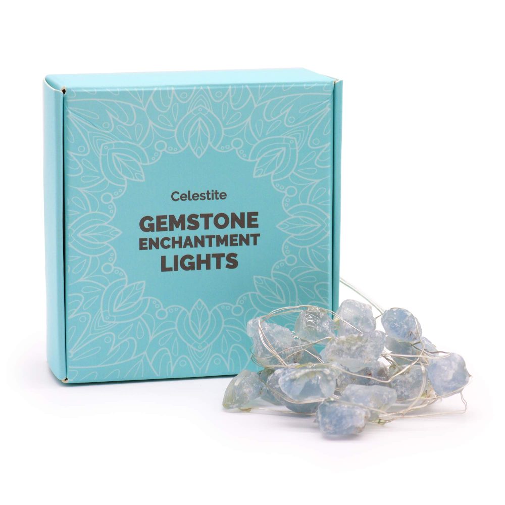 A light-blue box stands next to a pile of crystalline stones threaded with silver wire. The box reads, “Celestite GEMSTONE ENCHANTMENT LIGHTS” printed in a sans-serif font.