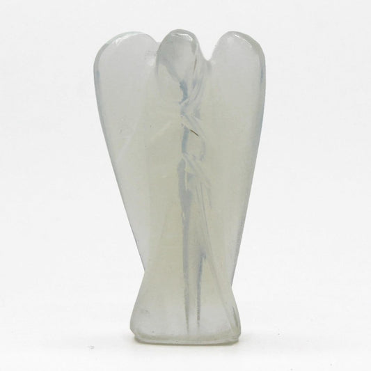 A carved, semi-translucent, off-white stone angel stands upright, wings spread, on a flat, white surface.