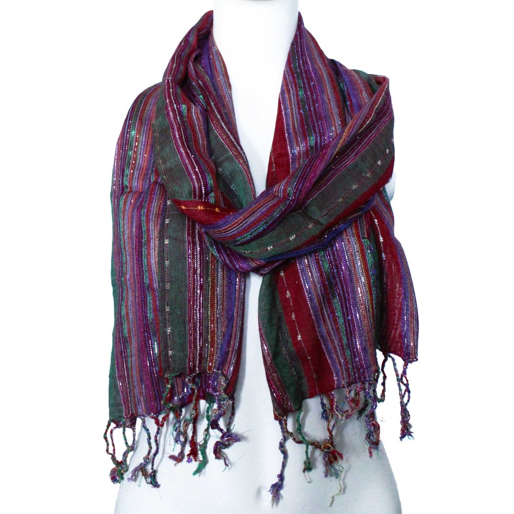 A striped scarf, tied around a mannequin's neck, displays maroon, green, purple, and gold threads.
