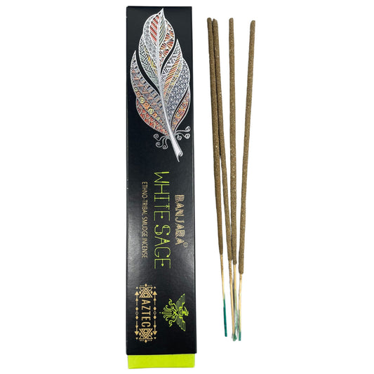 Incense sticks next to a decorative black box featuring a colorful feather design. Text reads: "Banjara White Sage Ethno Tribal Smudge Incense" and "Aztec" with tribal motifs.