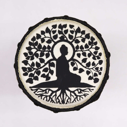 A circular design features a silhouette of a meditating figure under a tree with spreading branches and roots, set against a white background, creating a sense of tranquility.