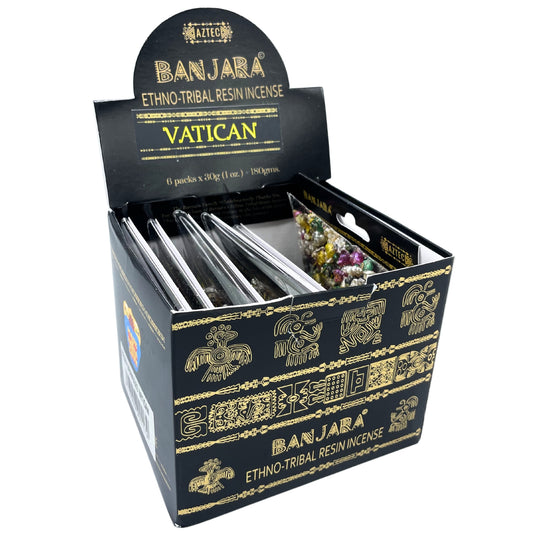 A box labeled "Banjara Ethno-Tribal Resin Incense" displays six packs of colorful resin pieces. The box features gold tribal designs and text: "Vatican," "Aztec," and mentions a total weight of 180 grams.