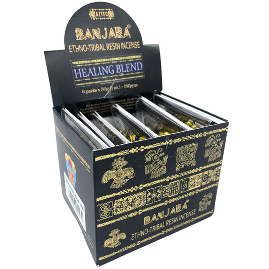Incense packets displayed in a black box with gold tribal designs labeled "BANJARA ETHNO-TRIBAL RESIN INCENSE." Text reads "HEALING BLEND, 6 packs x 30g (1 oz) = 180gms."