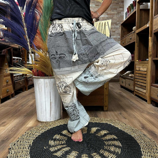 Printed harem pants are being modeled in a shop.  The pants feature various Asian-inspired designs.  The setting is a wooden-floored store with wooden furniture.