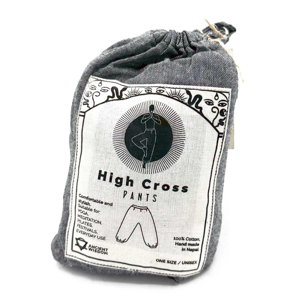 A gray cloth bag contains high-waisted pants; the bag's label depicts a person in a yoga pose and advertises the pants as comfortable and suitable for various activities.