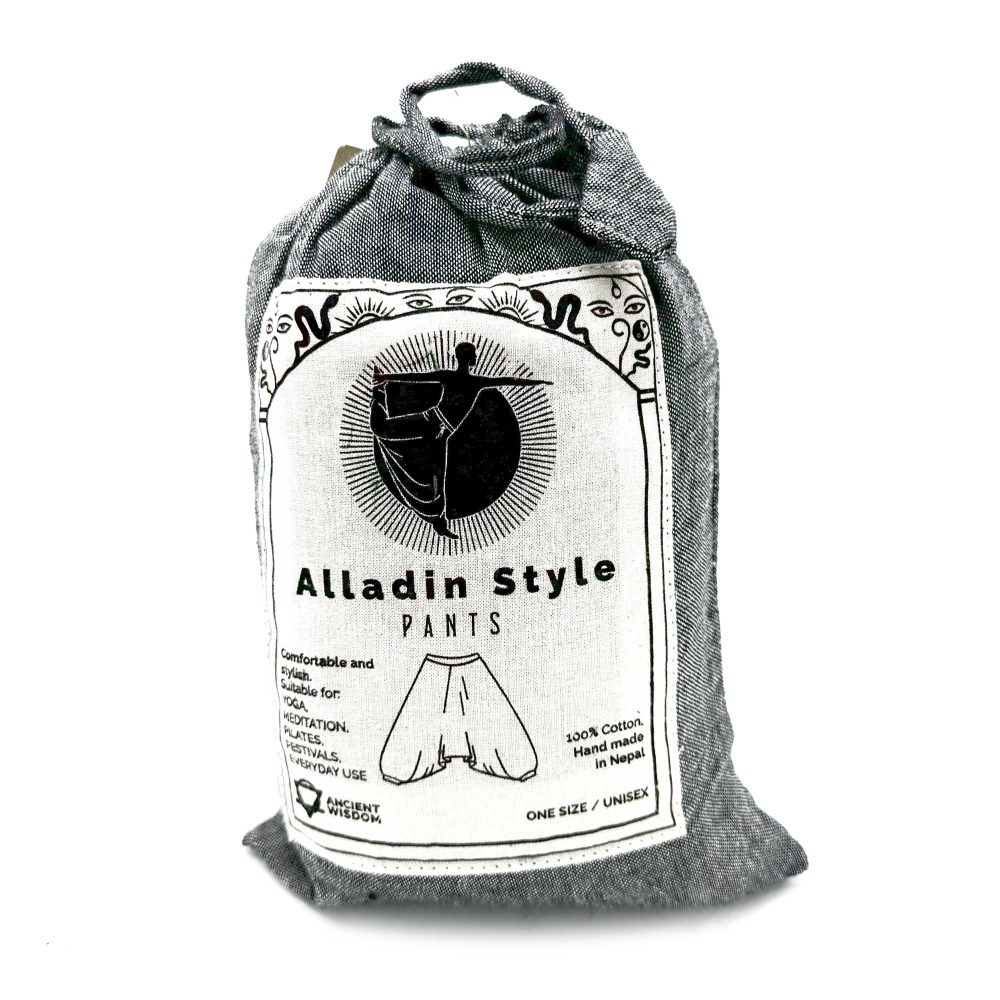 A gray fabric bag contains Aladdin-style pants; the bag displays details about the product, including its suitability for yoga and meditation, material, origin, and sizing.
