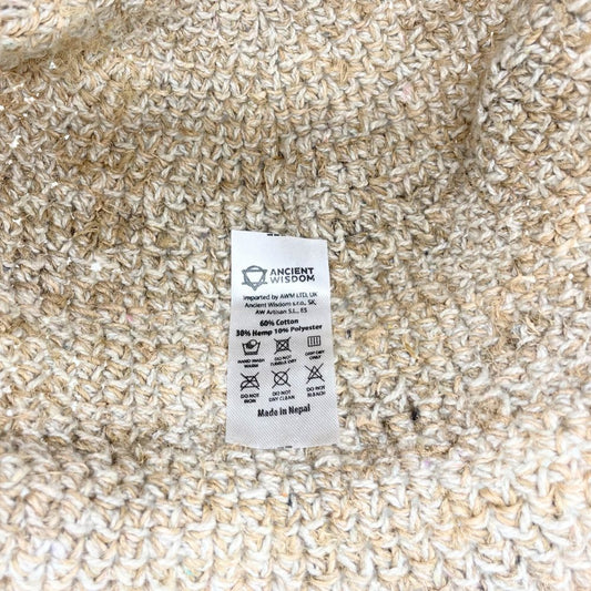 A beige knit fabric label displays a composition of 60% cotton, 30% hemp, and 10% polyester; it indicates care instructions and origin.
