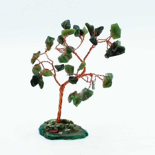 A copper-wire tree, adorned with dark-green stones as leaves, stands on a small, green base.
