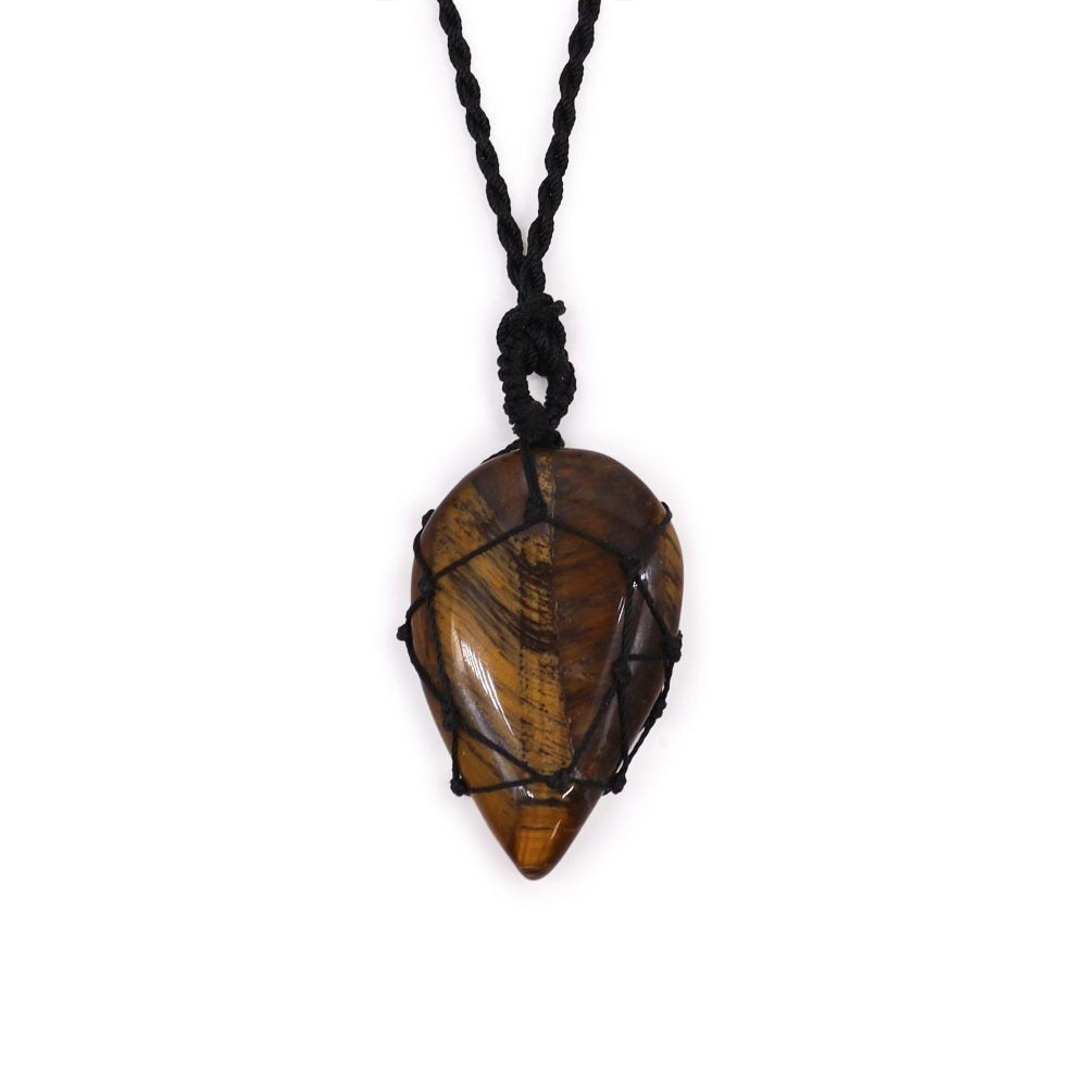 A brown-and-gold teardrop-shaped crystal hangs from a black knotted cord necklace, displayed against a stark white background.