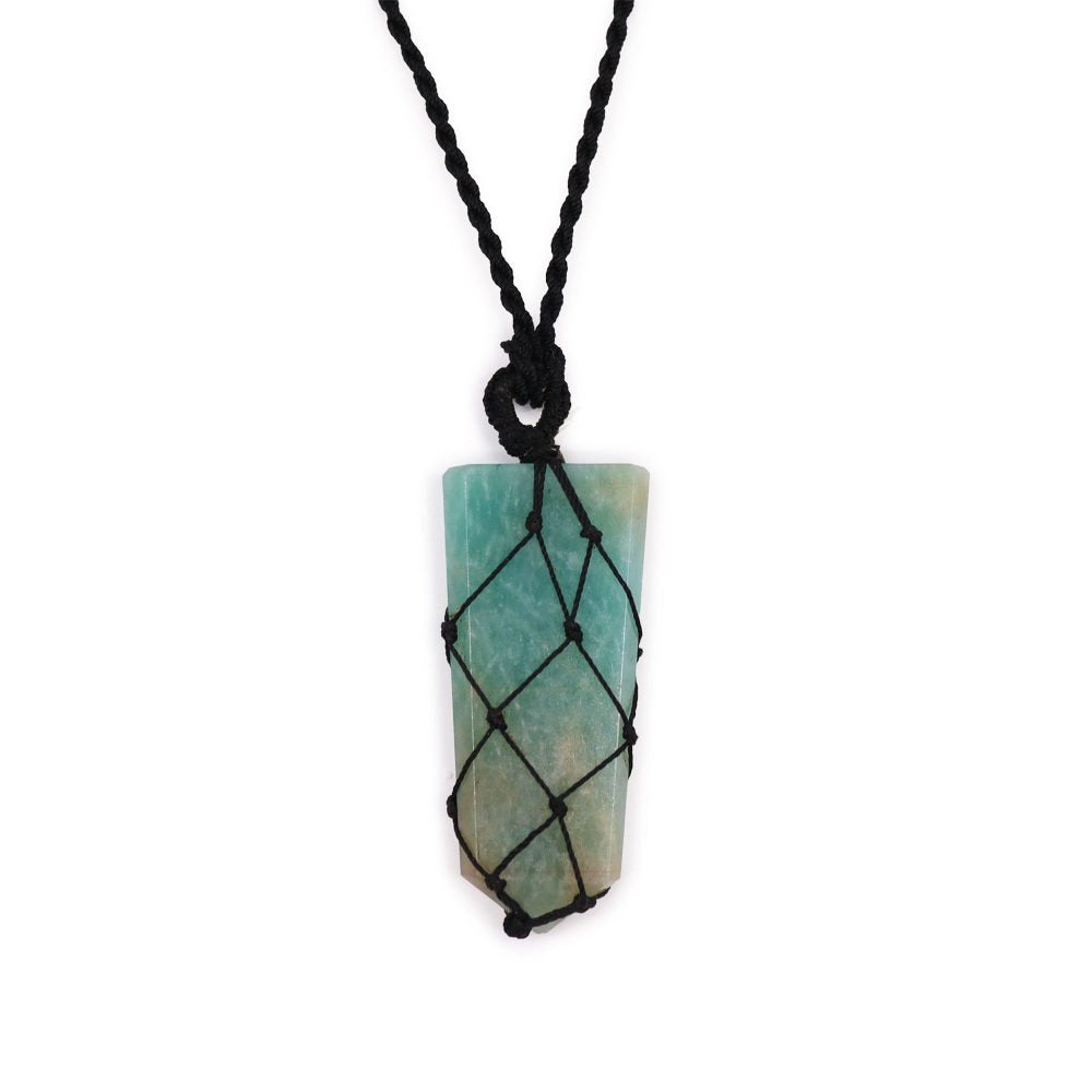 A rectangular, light blue-green mineral stone is enclosed by a black macrame net and hung on a braided black rope necklace, all displayed against a white background.